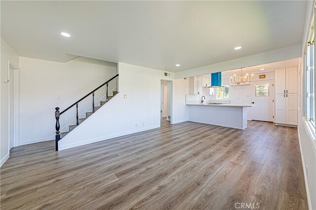1510 W 147th St, Gardena, CA 90247 - unfurnished living room with a chandelier, wood finished floors, stairs, and recessed lighting