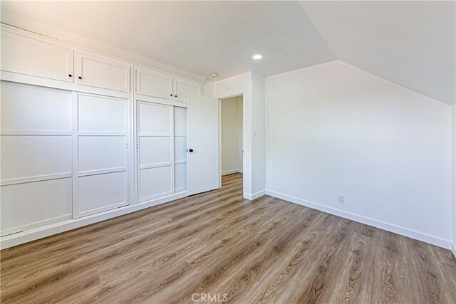 1510 W 147th St, Gardena, CA 90247 - unfurnished bedroom featuring light wood-style flooring, vaulted ceiling, a closet, and recessed lighting