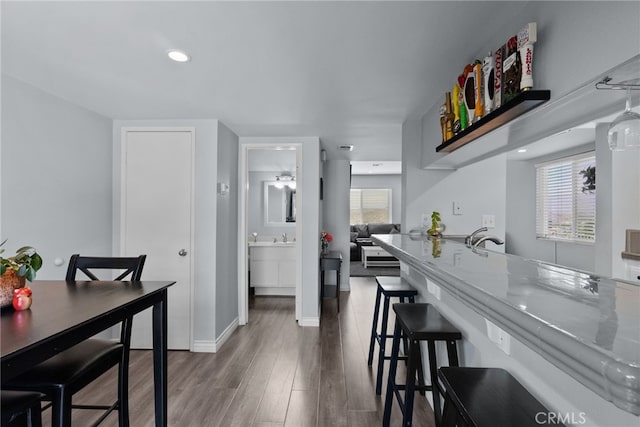 22524 Paseo Terraza, Saugus, CA 91350 - kitchen featuring wood finished floors, a breakfast bar area, and recessed lighting