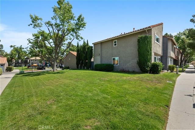 22524 Paseo Terraza, Saugus, CA 91350 - view of home's exterior featuring stucco siding, a lawn, and a residential view
