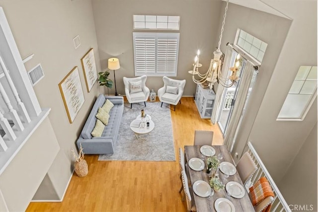 74 Garrison Loop, Ladera Ranch, CA 92694 - living area featuring wood finished floors, a towering ceiling, healthy amount of natural light, and stairs