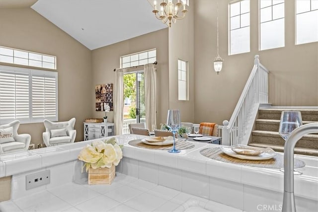 74 Garrison Loop, Ladera Ranch, CA 92694 - living room featuring high vaulted ceiling, a chandelier, and stairway