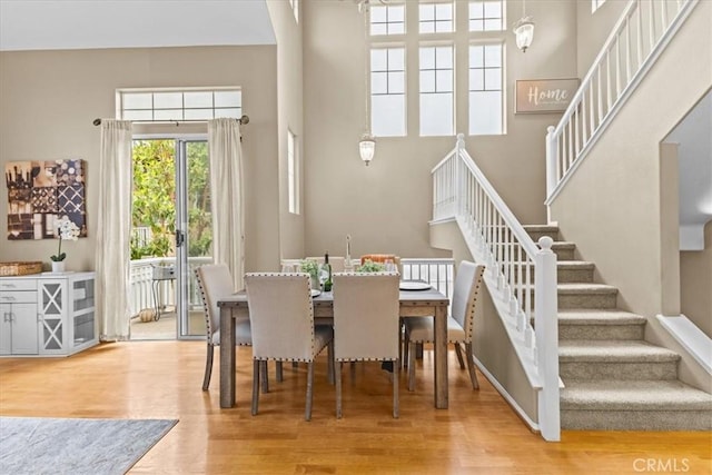 74 Garrison Loop, Ladera Ranch, CA 92694 - dining area featuring stairway, a towering ceiling, and wood finished floors