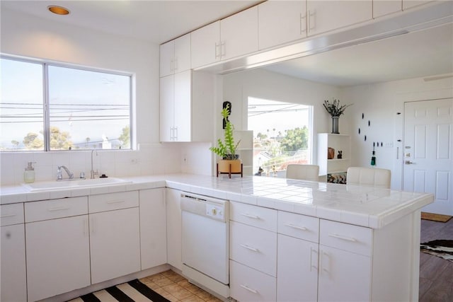 3311 Carolina S, San Pedro, CA 90731 - kitchen featuring white dishwasher, a peninsula, tile countertops, and white cabinetry