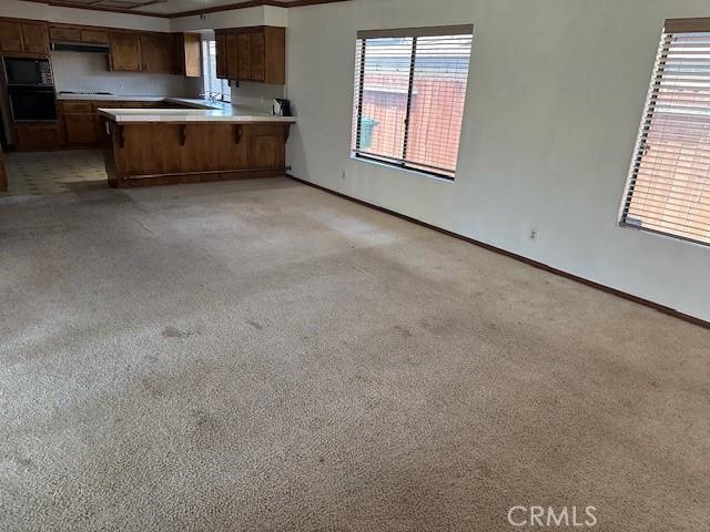 27208 Cornell St, Hemet, CA 92544 - kitchen featuring black appliances, light colored carpet, and healthy amount of natural light