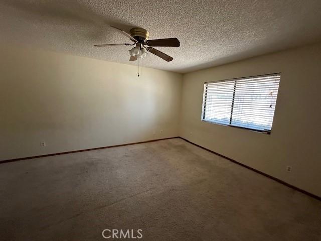 27208 Cornell St, Hemet, CA 92544 - carpeted empty room with a textured ceiling and ceiling fan