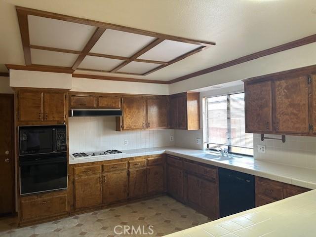 27208 Cornell St, Hemet, CA 92544 - kitchen featuring black appliances, tile counters, backsplash, under cabinet range hood, and light flooring