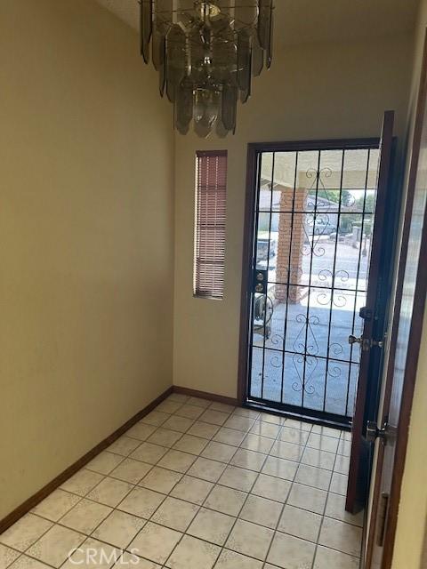 27208 Cornell St, Hemet, CA 92544 - unfurnished dining area featuring a chandelier and light tile patterned flooring