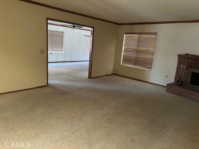 27208 Cornell St, Hemet, CA 92544 - unfurnished living room featuring crown molding, carpet flooring, a brick fireplace, and a textured ceiling