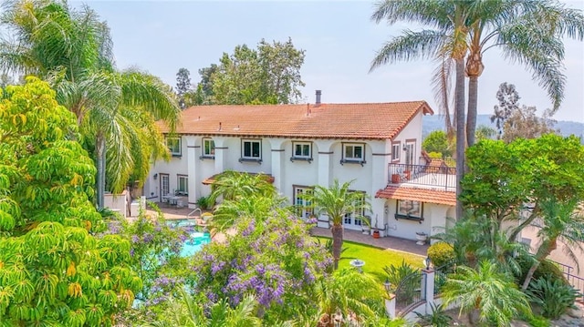 7680 E Eucalyptus Way, Anaheim Hills, CA 92808 - rear view of house with stucco siding, a tile roof, and a balcony