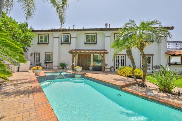7680 E Eucalyptus Way, Anaheim Hills, CA 92808 - back of house featuring stucco siding, french doors, a pool with connected hot tub, and a patio area