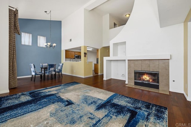 4722 Regatta Ln, San Diego, CA 92154 - living room with a chandelier, high vaulted ceiling, wood finished floors, and a tiled fireplace
