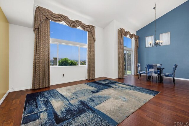 4722 Regatta Ln, San Diego, CA 92154 - living room with a chandelier, plenty of natural light, wood finished floors, and high vaulted ceiling