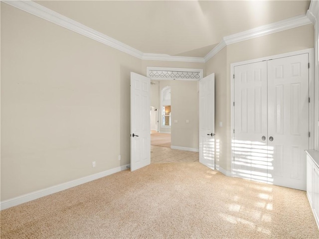 6660 N St Catherine Ct, Fresno, CA 93711 - unfurnished bedroom featuring crown molding, light colored carpet, a closet, and arched walkways