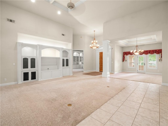 6660 N St Catherine Ct, Fresno, CA 93711 - unfurnished room with a chandelier, light carpet, light tile patterned flooring, a raised ceiling, and ornate columns