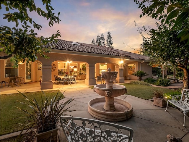 6660 N St Catherine Ct, Fresno, CA 93711 - back of property featuring stucco siding, a patio area, a tiled roof, and a yard