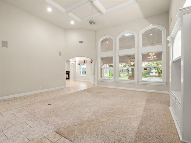 6660 N St Catherine Ct, Fresno, CA 93711 - unfurnished living room featuring arched walkways, coffered ceiling, light tile patterned floors, a high ceiling, and beamed ceiling