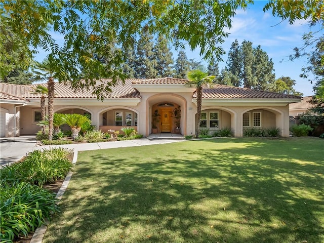6660 N St Catherine Ct, Fresno, CA 93711 - mediterranean / spanish house with stucco siding, a front lawn, and a tiled roof