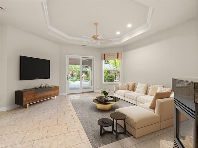 6660 N St Catherine Ct, Fresno, CA 93711 - living area with ceiling fan, a tray ceiling, recessed lighting, light tile patterned floors, and ornamental molding