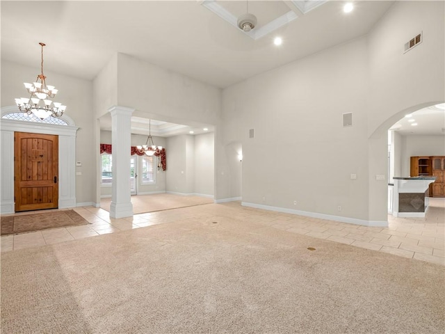 6660 N St Catherine Ct, Fresno, CA 93711 - foyer featuring a high ceiling, tile patterned floors, a chandelier, carpet, and ornate columns