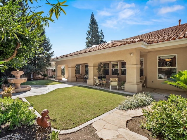 6660 N St Catherine Ct, Fresno, CA 93711 - rear view of house featuring stucco siding, a patio, and a tile roof