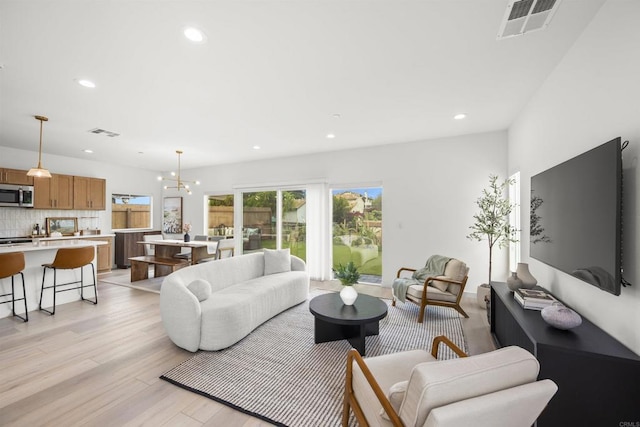 2210 Bonita Ct, Lemon Grove, CA 91945 - living room with recessed lighting, light wood-type flooring, and a chandelier