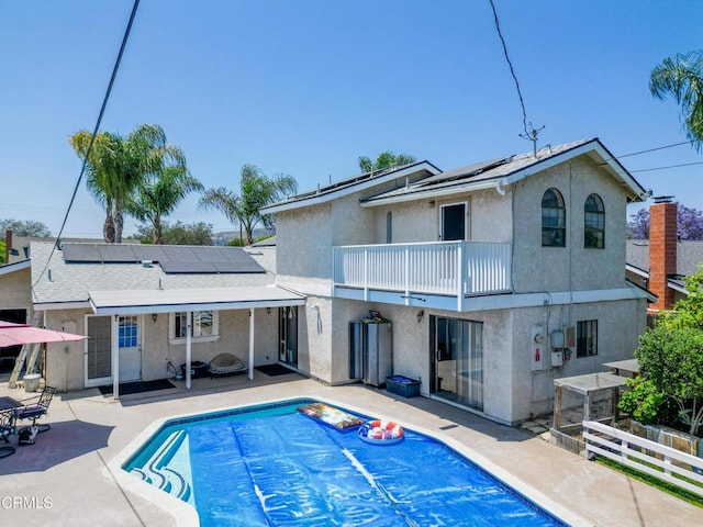 1742 Forar Cir, Camarillo, CA 93010 - back of property featuring a balcony, solar panels, stucco siding, and a patio area