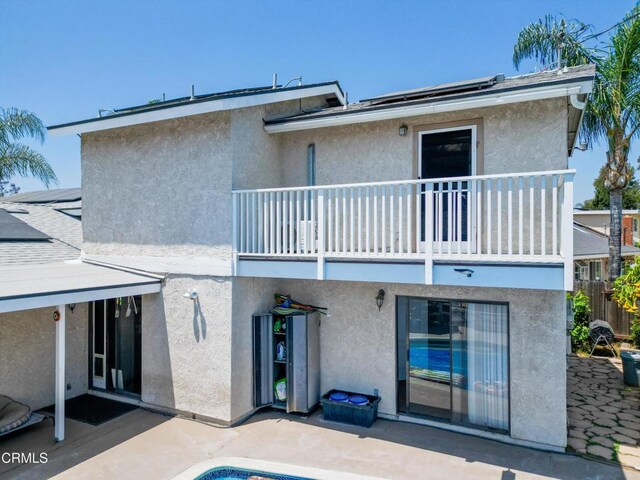 1742 Forar Cir, Camarillo, CA 93010 - rear view of property with a balcony, a patio, roof mounted solar panels, and stucco siding