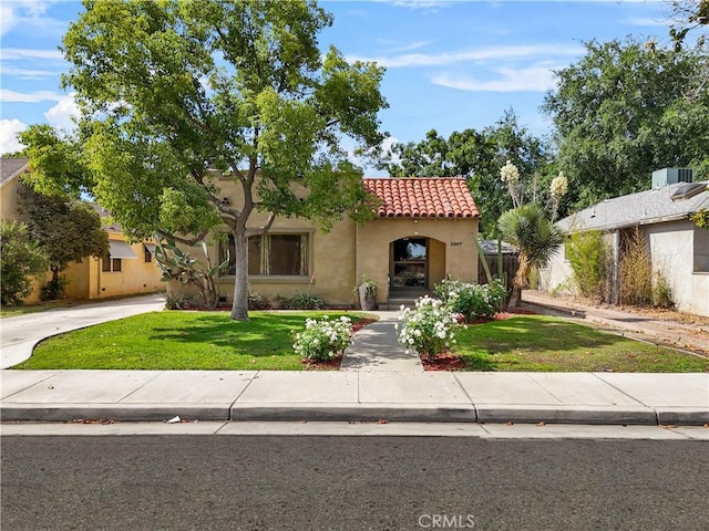 3007 Park Way, Bakersfield, CA 93304 - mediterranean / spanish house with a tile roof, stucco siding, a front lawn, and driveway