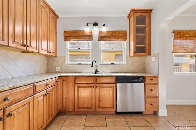 3007 Park Way, Bakersfield, CA 93304 - kitchen with dishwasher, light stone counters, light tile patterned flooring, and brown cabinets