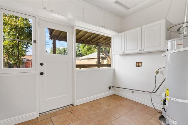 3007 Park Way, Bakersfield, CA 93304 - washroom featuring cabinet space, electric dryer hookup, strapped water heater, hookup for a washing machine, and light tile patterned floors