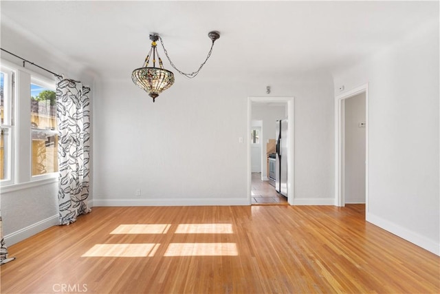 3007 Park Way, Bakersfield, CA 93304 - empty room with light wood-style floors and a chandelier