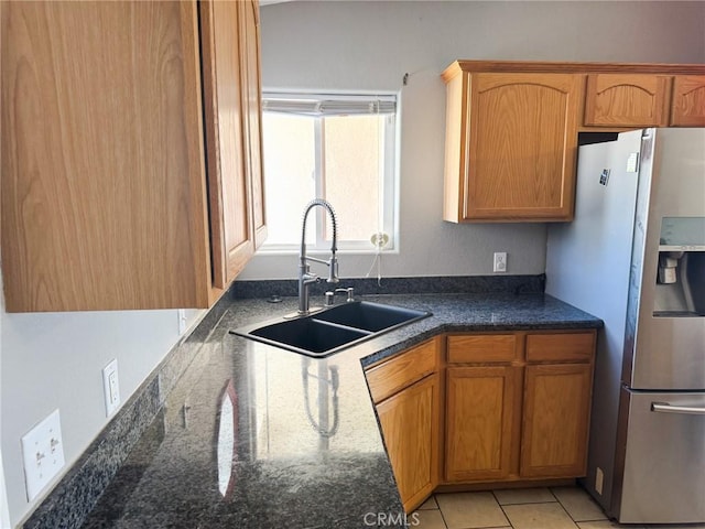 6025 Abronia Ave Unit 29, Palms, CA 92277 - kitchen featuring stainless steel fridge with ice dispenser, brown cabinets, and dark stone counters