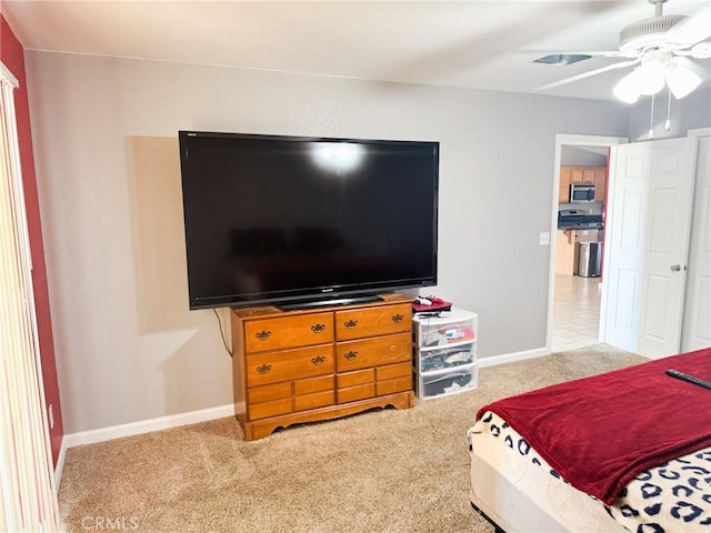 6025 Abronia Ave Unit 29, Palms, CA 92277 - carpeted bedroom with baseboards and a ceiling fan