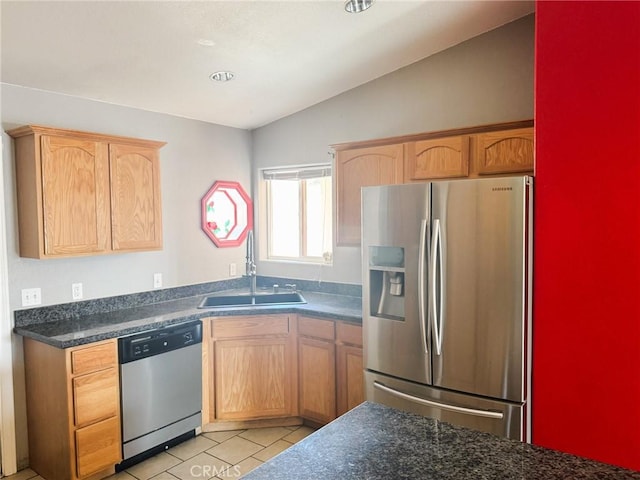 6025 Abronia Ave Unit 29, Palms, CA 92277 - kitchen featuring stainless steel appliances, lofted ceiling, dark countertops, and light tile patterned floors