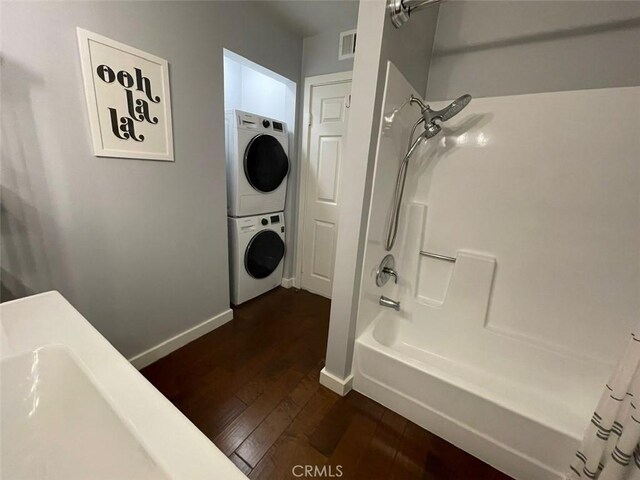3641 S Bear St Unit F, Santa Ana, CA 92704 - bathroom with stacked washer and clothes dryer, wood-type flooring, and  shower combination