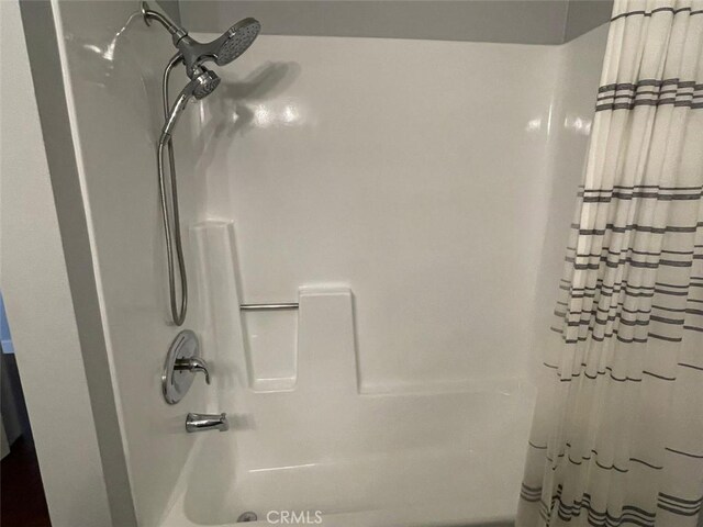 3641 S Bear St Unit F, Santa Ana, CA 92704 - bathroom featuring shower / bath combo with shower curtain