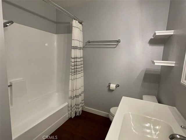 3641 S Bear St Unit F, Santa Ana, CA 92704 - full bathroom with shower / tub combo with curtain and wood finished floors