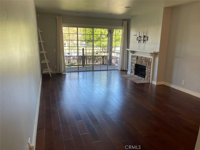 3641 S Bear St Unit F, Santa Ana, CA 92704 - unfurnished living room with dark wood-style flooring and a fireplace