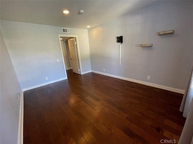 3641 S Bear St Unit F, Santa Ana, CA 92704 - unfurnished room featuring dark wood-type flooring and recessed lighting