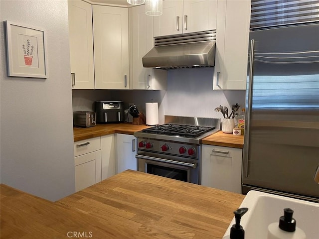 3641 S Bear St Unit F, Santa Ana, CA 92704 - kitchen featuring wood counters, high end appliances, under cabinet range hood, and white cabinets