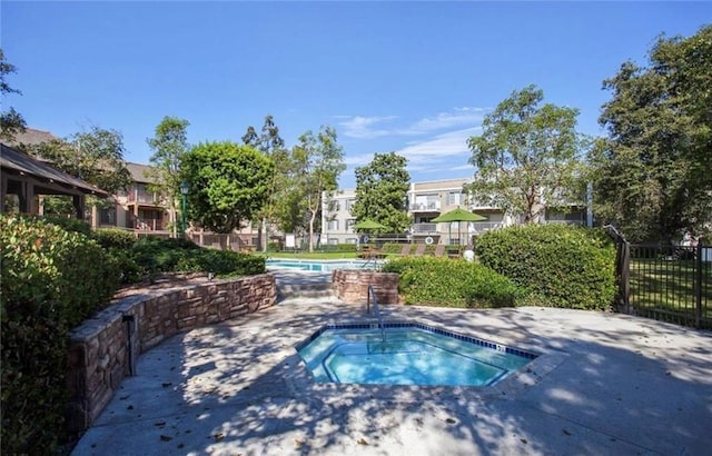 3641 S Bear St Unit F, Santa Ana, CA 92704 - view of swimming pool with a hot tub and a patio area