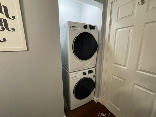 3641 S Bear St Unit F, Santa Ana, CA 92704 - washroom featuring stacked washer and clothes dryer and baseboards