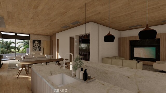 32512 Seven Seas Dr, Dana Point, CA 92629 - kitchen featuring wooden ceiling, light wood-style floors, light stone counters, pendant lighting, and a fireplace