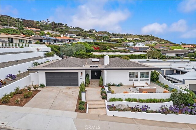 32512 Seven Seas Dr, Dana Point, CA 92629 - view of front of home featuring concrete driveway, an attached garage, a fenced backyard, and a residential view