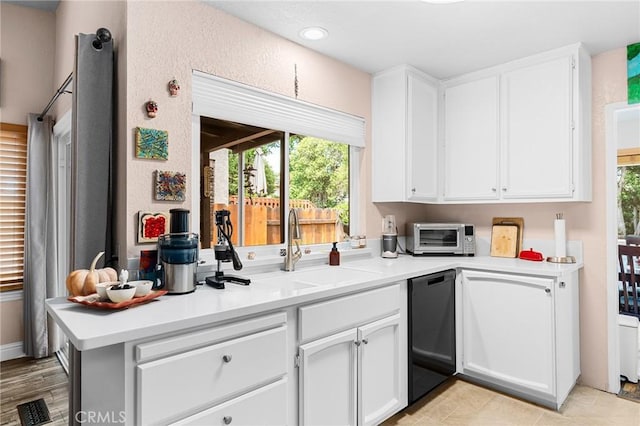 11 Tilden Ln, Chico, CA 95928 - kitchen with dishwashing machine, white cabinets, light countertops, and recessed lighting