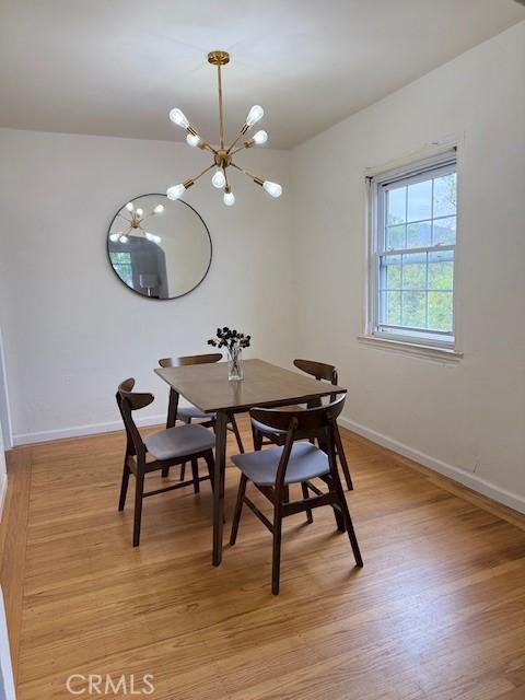 4544 Tulip Ave, Oakland, CA 94619 - dining room with a chandelier and light wood-style floors