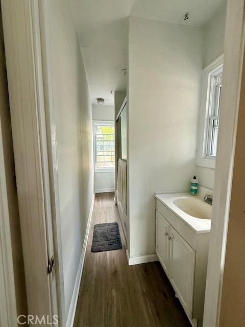 4544 Tulip Ave, Oakland, CA 94619 - bathroom featuring vanity, wood finished floors, and a shower with door