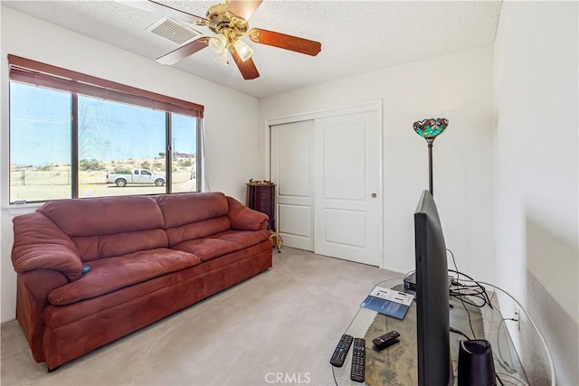 6333 Carodean Rd Unit 29, Palms, CA 92277 - living room featuring light colored carpet, a ceiling fan, and a textured ceiling