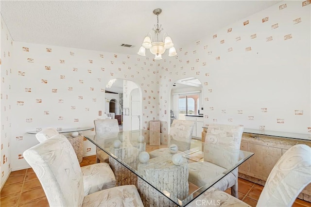 6333 Carodean Rd Unit 29, Palms, CA 92277 - dining room featuring arched walkways, a chandelier, and light tile patterned flooring